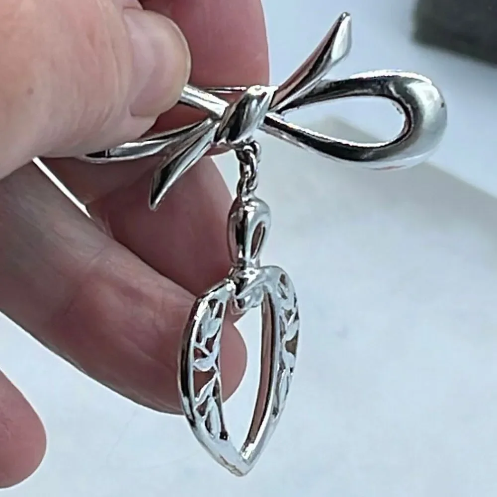 Vintage stylized bow and dangle heart brooch